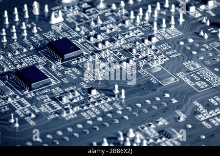 Close-up electronic circuit board with micro chips from a home appliance or laptop electronics and complex devices. Concept of microchips and future t Stock Photo