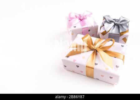 Three gift boxes with bows on a white background. Stock Photo