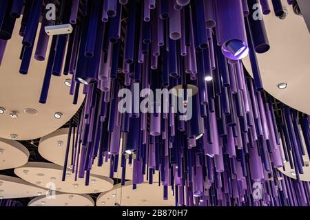 Purple abstract background of geometric shapes and lines. Creative lighting equipment on ceiling. Futuristic patterned backdrop with copy space. Stock Photo