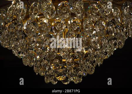 Abstract shiny glass texture closeup. Sparkle crystal hangings of luxury chandelier on black background. Vintage brilliant glass surface. Pattern Stock Photo
