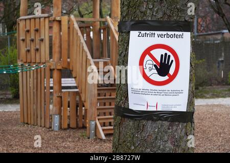 Hannover, Germany - March 20, 2020: Closed playground with Zutritt verboten - meaning no entry in German - prohibition sign as social distancing measure during corona epidemic crisis