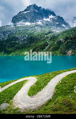 Winding Path in the Alps with a Mountain in the Background Stock Photo