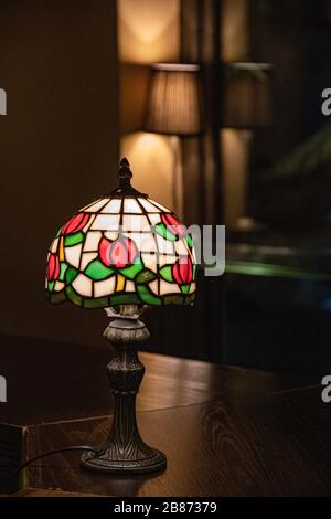 Stained Glass Lampshade With Floral Pattern Closeup On Dark Blurred Background Shiny Mosaic Lamp Atop Wooden Table Surface Vintage Ornate Lamp Shade Stock Photo Alamy