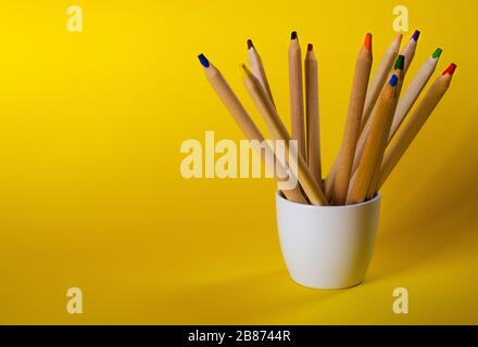 multi colored pencils on a yellow background 4 Stock Photo