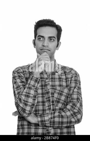 Portrait of young Persian hipster man thinking Stock Photo