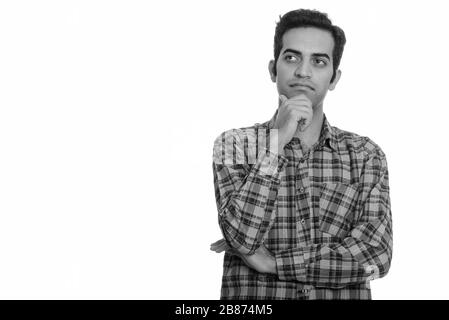 Portrait of young Persian hipster man thinking Stock Photo