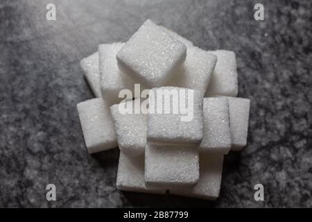 Sugar cubes stacked in a pile Stock Photo