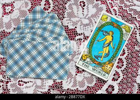 Rider Tarot Cards designed by Pamela Colman Smith under supervision of Arthur Edward Waite on cloth with The World tarot card upturned Stock Photo