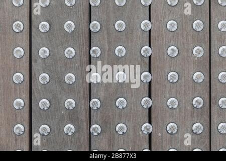 The texture of the floorboards with iron rivets Stock Photo