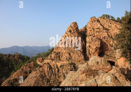 panorama of the road called D81 in Corsica France and the red rocks at sunset Stock Photo