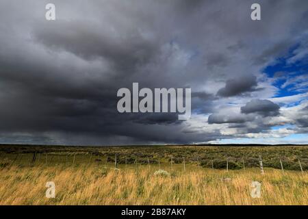 Dramatic clouds over the Patagonia Steppe desert, near Punta Arenas city, Patagonia, Chile, South America Stock Photo