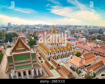 Aerial View With Drone. Wat Ratchanatdaram and Loha Prasat Metal Castle in the twilight time, Landmark of Bangkok Thailand. Stock Photo