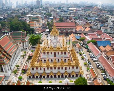Aerial View With Drone. Wat Ratchanatdaram and Loha Prasat Metal Castle in the twilight time, Landmark of Bangkok Thailand. Stock Photo