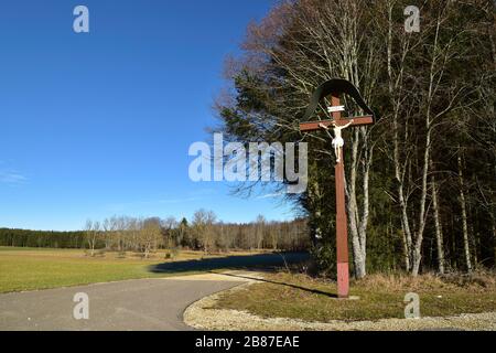 Cross on crossroad. Old wooden christian roadside cross. Stock Photo