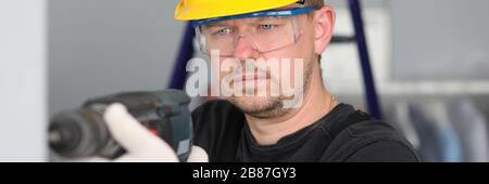 Worker with drill in room Stock Photo