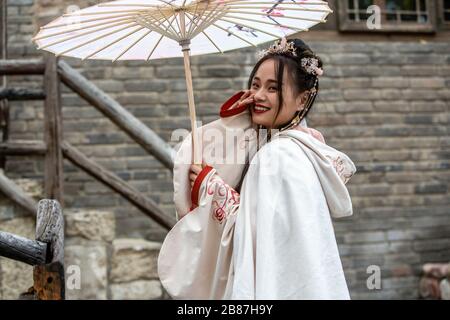 Chinese girl with umbrella at Gubei Water Town, Beijing, China Stock Photo