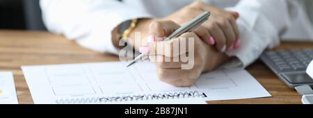 Female writing down in schedule Stock Photo