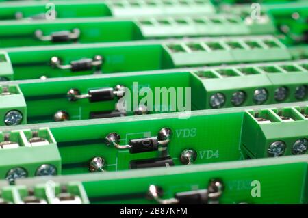 A large number of green boards with electronic components. Complex electronic equipment concept in a factory Stock Photo