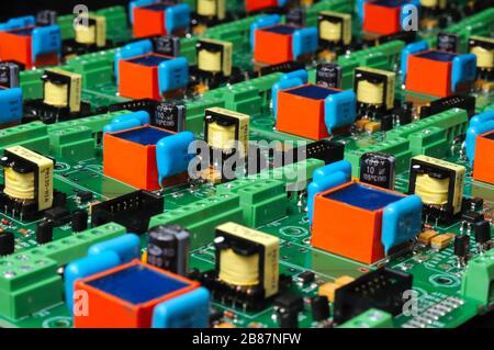 A large number of green boards with electronic components. Complex electronic equipment concept in a factory Stock Photo