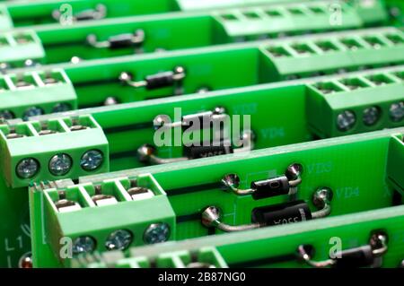 A large number of green boards with electronic components. Complex electronic equipment concept in a factory Stock Photo