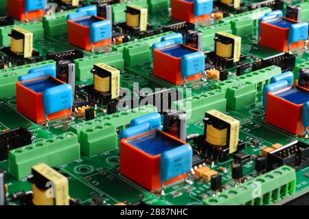 A large number of green boards with electronic components. Complex electronic equipment concept in a factory Stock Photo