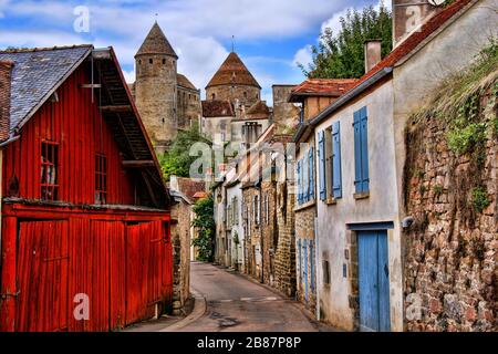 Old picturesque lane with medieval towers in the village of Semur en Auxois, Burgundy, France Stock Photo