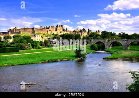 View of the medieval walled city of Carcassonne, France from a riverside park with historic bridge Stock Photo