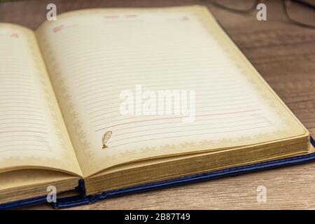 Vintage book, open, on old wooden table. Education concept picture Stock Photo
