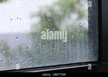Water of Raindrops fresh on surface window glass in rainy season (Selective focus) Stock Photo