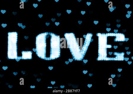 blurred text blue LOVE sign LED Bokeh neon light blue on background bokeh lights heart soft colorful Stock Photo