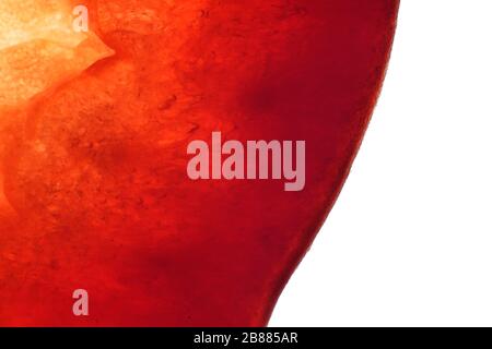Creative, colorful macro image of red pepper slice. Abstract, fresh, fruity background with enhanced texture, fibers and seeds. Stock Photo