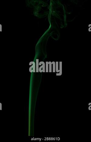 Abstract green smoke swirling on a black background. Stock Photo