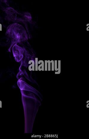 Abstract purple smoke swirling on a black background. Stock Photo