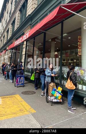 New York, NY, USA. 30th Mar, 2020. Line forming outside of Trader JoeÕs in Chelsea after NYÕs Governor Cuomo instituted a 100% work at home policy to combat the spread of the Coronavirus on March 20, 2020 in NE York City. Credit: Rainmaker Photo/Media Punch/Alamy Live News Stock Photo