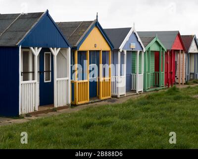 Beach huts along the promenade between Sandilands and Maplethorpe, Lincolnshire, UK Stock Photo