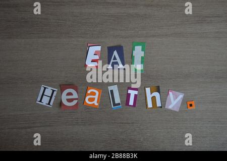 Sentence 'Eat Healthy' made with a collage of different typography letters Stock Photo