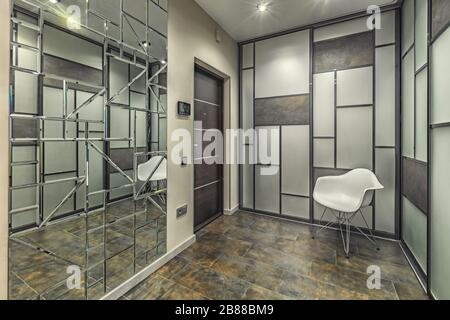 Empty residential house entrance with closed doors build in closets with mirrors Stock Photo