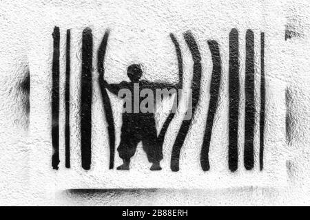 Graffiti depicting a man escaping from prison. Concept of escape, protest against the system. Power and control.