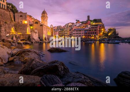 View of Vernazza one of Cinque Terre in the province of La Spezia, Italy, happy young couple picnic in the mountain with a look over the ocean Stock Photo