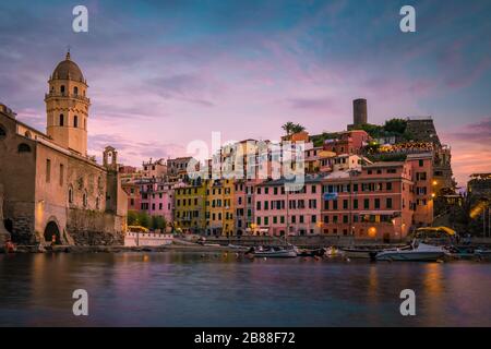 View of Vernazza one of Cinque Terre in the province of La Spezia, Italy, happy young couple picnic in the mountain with a look over the ocean Stock Photo