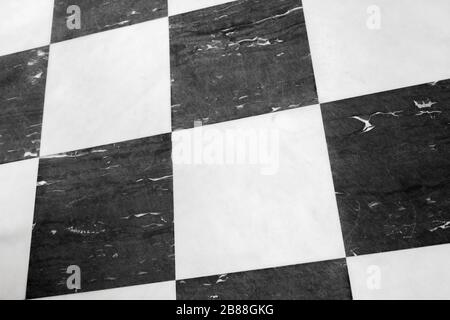 Marble floor tiling with classical black and white checker pattern Stock Photo