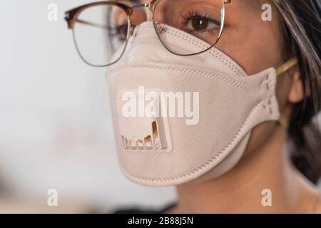 Coronavirus. Woman at the office sick with mask for corona virus. Business women wear masks to protect and take care of their health. Home working Stock Photo