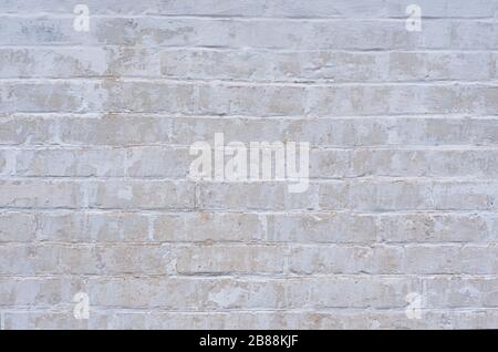 White weathered wall, peeling wall, made of silicate brick. Texture. Stock Photo