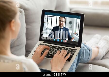 Computer screen monitor view over female shoulder Stock Photo