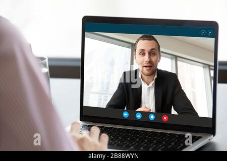 Businesswoman having distant talk with colleague through videocall screen view Stock Photo
