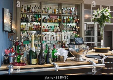 the well stocked bar in the Palm Court Lounge of the art deco Burgh Island Hotel. Burgh Island, Devon, England, UK Stock Photo