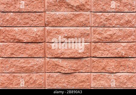 Wall texture of brown brick tiles with gray, beige and yellow granite splashes. Stock Photo