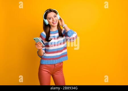 Portrait of her she nice attractive lovely cheerful cheery brown-haired girl listening hard rock pop hip hop glam hobby spring isolated on bright Stock Photo