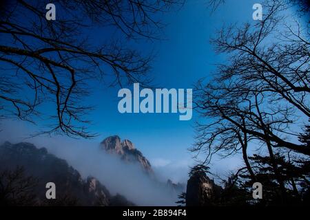 A mist floats along a stunning view of part of the Yellow Mountains in Anhui Province,  China. Stock Photo