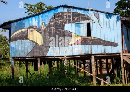 Indian stilted house on the Amazon river embankment, on the other side of Leticia port Colombia in Peru, South America. Stock Photo